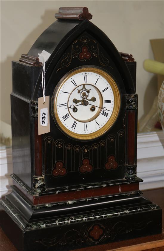 A Victorian aesthetic movement black slate and rouge marble 8-day mantel clock